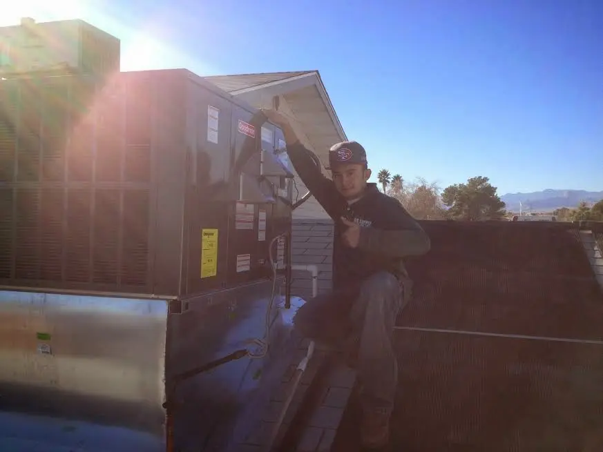 HVAC technician performing Boiler Repair on a rooftop unit in Arcata
